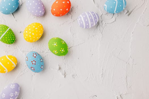 Easter Day Concept. Top view holiday banner background web design white colorful easter eggs painted on white cement background with empty copy space, celebration greeting card, overhead, template