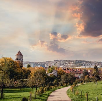 Germany, Stuttgart panorama view. Beautiful houses in autumn, Sky and nature landscape. Vineyards in Stuttgart - colorful wine growing region in the south of Germany with view over Neckar Valley. Germany, Stuttgart city panorama view above vineyards, industry, houses, streets, stadium and highway at sunset in warm orange light.