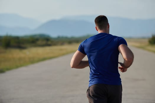 An athletic man exudes determination as he runs, embodying a commitment to a healthy lifestyle and preparation for an upcoming marathon competition