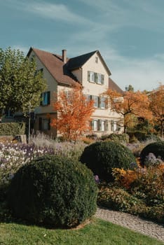 House with nice garden in fall. Flowers in the Park. Bietigheim-Bissingen. Germany, Europe. Autumn Park and house, nobody, bush and grenery