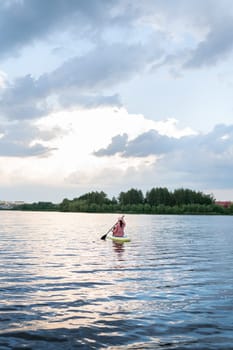 A lone kayaker girl on a serene lake, surrounded by nature under a diffused, cloudy sky