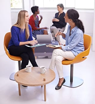 Collaboration, women and communication with business meeting in modern office for creative planning and listening. Designer, employees and teamwork with discussion, notes or ideas for magazine design.