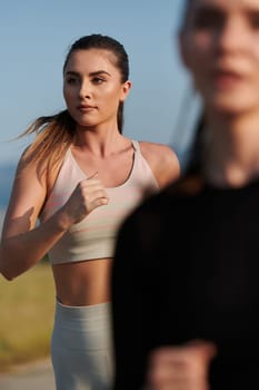 An athletic woman finds freedom and joy in a healthy lifestyle, running through a beautiful road trail at sunrise.