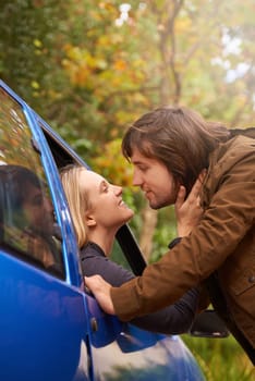 Transport, travel and couple in car for goodbye, greeting and love for journey, leaving and commute. Road trip, driving and man and woman in vehicle window for bonding, relationship and embrace.