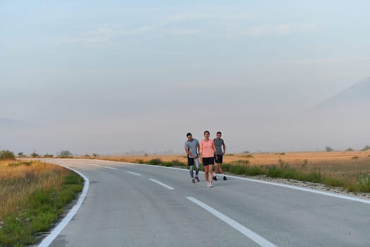 A group of friends, athletes, and joggers embrace the early morning hours as they run through the misty dawn, energized by the rising sun and surrounded by the tranquil beauty of nature.