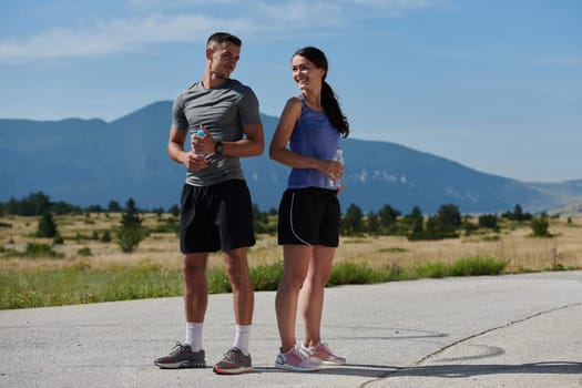 In a serene moment of post-run tranquility, a romantic couple rests together, embodying both exhaustion and affection after a rigorous training session.