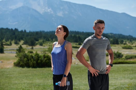 In a serene moment of post-run tranquility, a romantic couple rests together, embodying both exhaustion and affection after a rigorous training session.