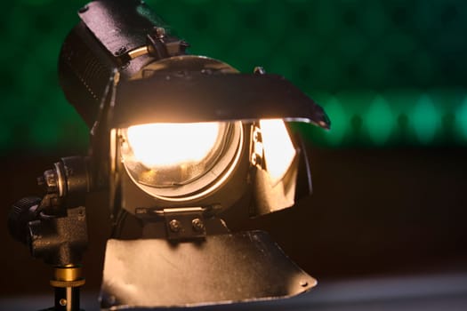 Close-up of a professional lighting fixture on a set or photographic studio. Concept of shooting a movie. color