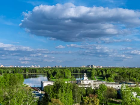 Beautiful view of the city park. Clouds on a sunny summer day