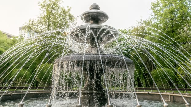 Round fountain in the city park on a summer day. natural color