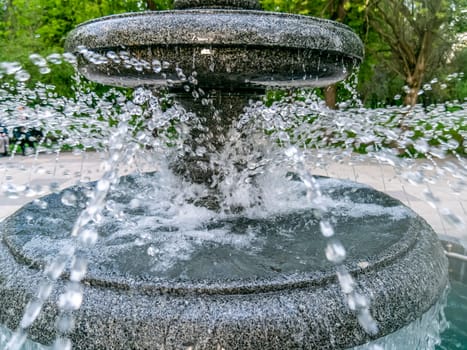 Round fountain in the city park on a summer day. natural color