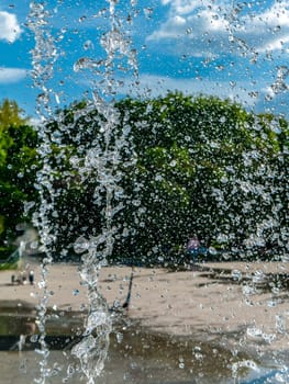 Fountain water jets working in a city park.