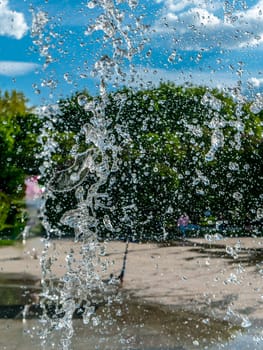 Fountain water jets working in a city park.