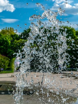 Fountain water jets working in a city park.