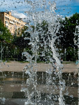 Fountain water jets working in a city park.