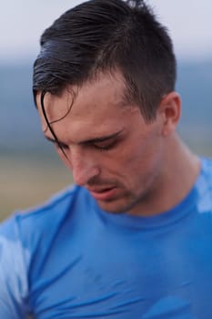 After completing a grueling daily run, a sweaty athlete takes a well-deserved rest, showcasing the physical exertion and dedication of their training regimen.