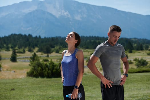 In a serene moment of post-run tranquility, a romantic couple rests together, embodying both exhaustion and affection after a rigorous training session.