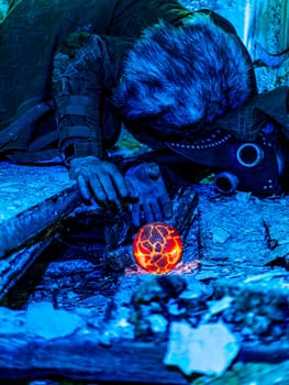 Cosplay of a stalker lying on the floor of an abandoned house in a plague doctor mask and holding a mysterious artifact. art photo