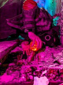 Cosplay of a stalker lying on the floor of an abandoned house in a plague doctor mask and holding a mysterious artifact. art photo