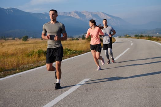 A group of friends maintains a healthy lifestyle by running outdoors on a sunny day, bonding over fitness and enjoying the energizing effects of exercise and nature.