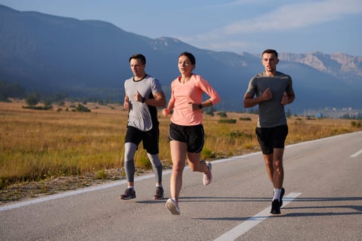 A group of friends maintains a healthy lifestyle by running outdoors on a sunny day, bonding over fitness and enjoying the energizing effects of exercise and nature.