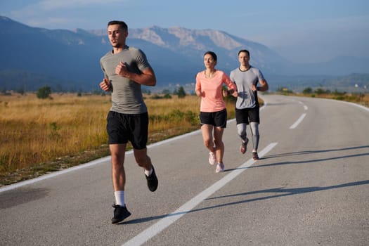 A group of friends maintains a healthy lifestyle by running outdoors on a sunny day, bonding over fitness and enjoying the energizing effects of exercise and nature.