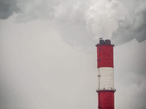 smoke coming out of a large factory chimney. Close-up of smoke coming out of chimneys against the sky. Air pollution concept.