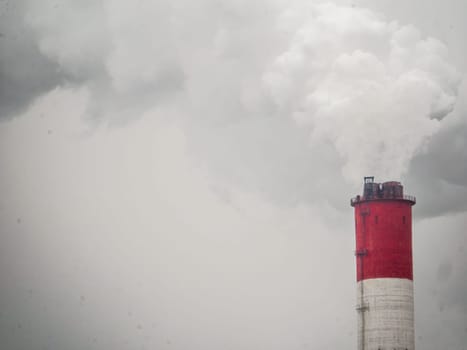 smoke coming out of a large factory chimney. Close-up of smoke coming out of chimneys against the sky. Air pollution concept.