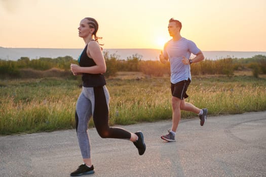 A diverse group of runners finds motivation and inspiration in each other as they train together for an upcoming competition, set against a breathtaking sunset backdrop.