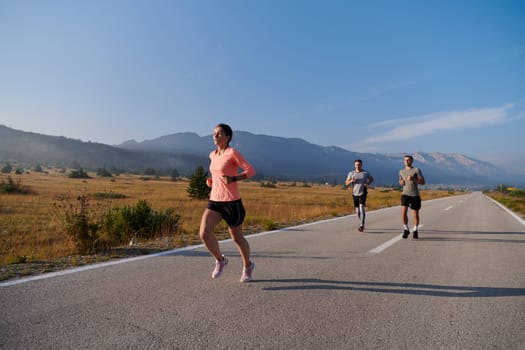 A group of friends maintains a healthy lifestyle by running outdoors on a sunny day, bonding over fitness and enjoying the energizing effects of exercise and nature.