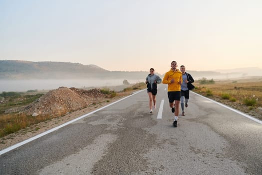 A group of friends, athletes, and joggers embrace the early morning hours as they run through the misty dawn, energized by the rising sun and surrounded by the tranquil beauty of nature.