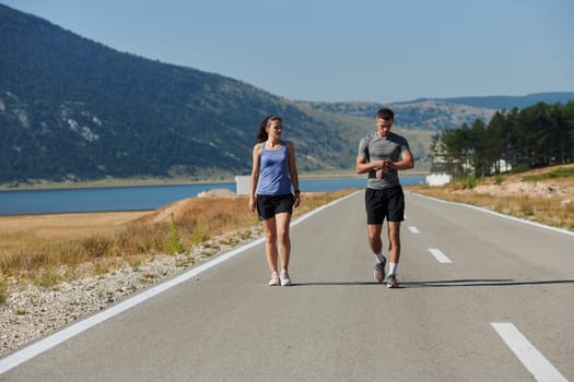 In a serene moment of post-run tranquility, a romantic couple rests together, embodying both exhaustion and affection after a rigorous training session.