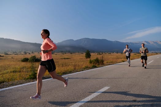 A group of friends maintains a healthy lifestyle by running outdoors on a sunny day, bonding over fitness and enjoying the energizing effects of exercise and nature.