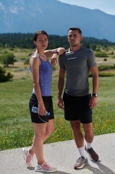 In a serene moment of post-run tranquility, a romantic couple rests together, embodying both exhaustion and affection after a rigorous training session.