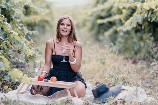 Picnic and wine tasting at sunset in the hills of Italy, Tuscany. Vineyards and open nature in the summer. Romantic dinner, fruit and wine.