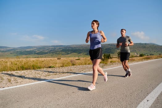 A couple runs through a sun-dappled road, their bodies strong and healthy, their love for each other and the outdoors evident in every stride.