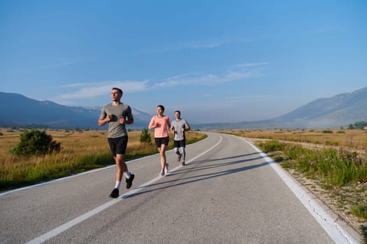 A group of friends maintains a healthy lifestyle by running outdoors on a sunny day, bonding over fitness and enjoying the energizing effects of exercise and nature.