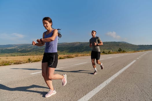 A couple runs through a sun-dappled road, their bodies strong and healthy, their love for each other and the outdoors evident in every stride.