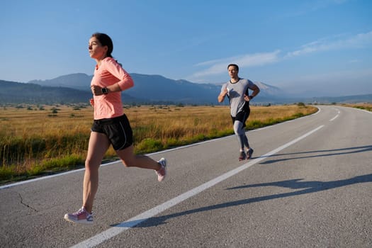 A couple runs through a sun-dappled road, their bodies strong and healthy, their love for each other and the outdoors evident in every stride.