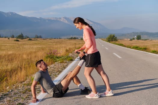 As dawn breaks, a romantic couple engages in a gentle stretch together, symbolizing their shared dedication and preparation for an invigorating early morning run.