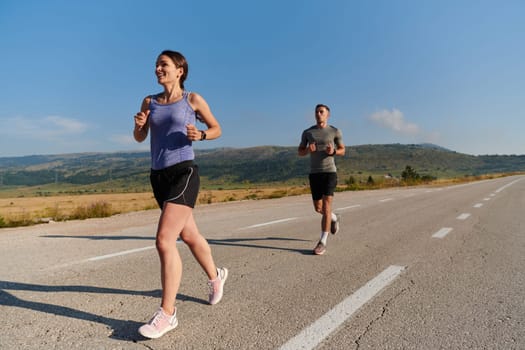 A couple runs through a sun-dappled road, their bodies strong and healthy, their love for each other and the outdoors evident in every stride.