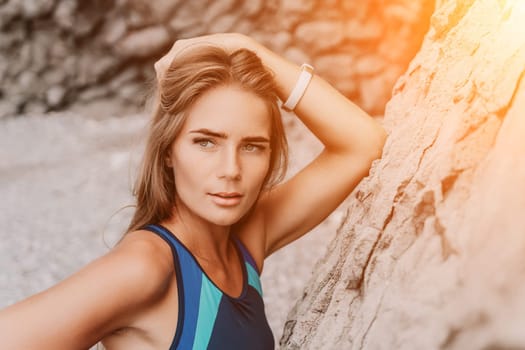 Woman travel sea. Young Happy woman in a long red dress posing on a beach near the sea on background of volcanic rocks, like in Iceland, sharing travel adventure journey