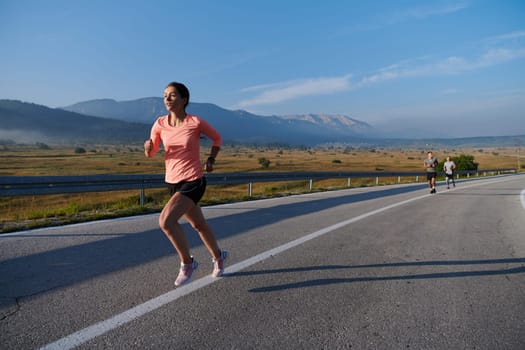 A resolute and motivated athlete running confidently into the sunrise, epitomizing determination and empowerment in her early morning run.