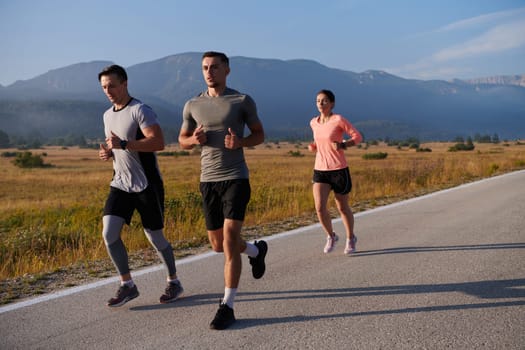 A group of friends maintains a healthy lifestyle by running outdoors on a sunny day, bonding over fitness and enjoying the energizing effects of exercise and nature.