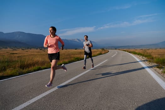 A couple runs through a sun-dappled road, their bodies strong and healthy, their love for each other and the outdoors evident in every stride.