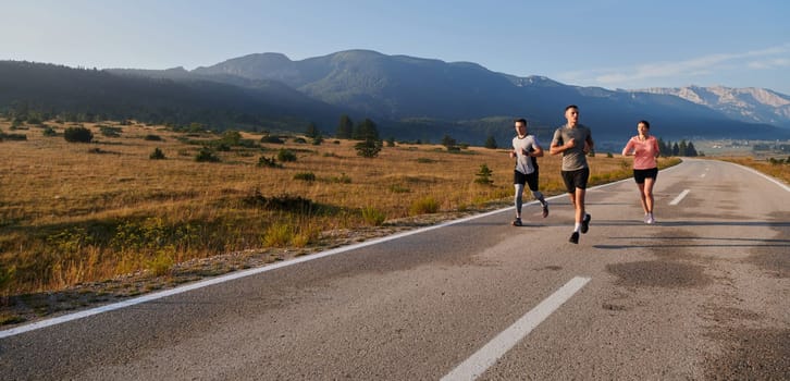 A group of friends maintains a healthy lifestyle by running outdoors on a sunny day, bonding over fitness and enjoying the energizing effects of exercise and nature.