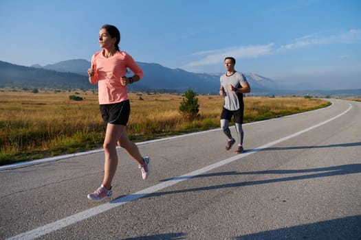 A couple runs through a sun-dappled road, their bodies strong and healthy, their love for each other and the outdoors evident in every stride.