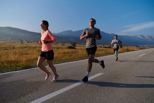 A group of friends maintains a healthy lifestyle by running outdoors on a sunny day, bonding over fitness and enjoying the energizing effects of exercise and nature.