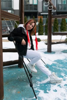 European woman in winter clothes walking on the playground.