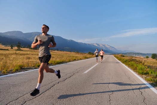 A group of friends maintains a healthy lifestyle by running outdoors on a sunny day, bonding over fitness and enjoying the energizing effects of exercise and nature.